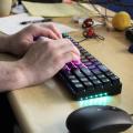 Hands typing on lighted mechanical keyboard
